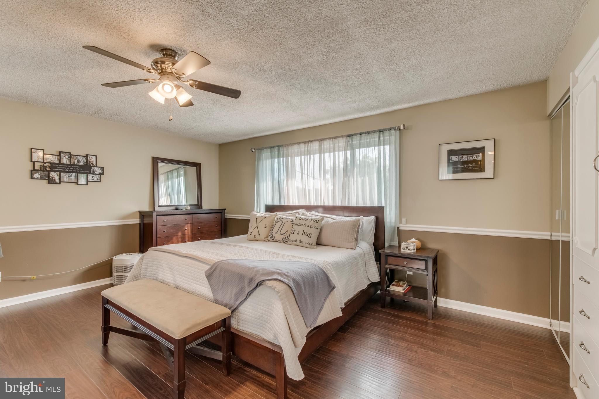 1519 National Road Baltimore, MD 21237 - Photo 8 of 30 a bedroom with a bed and a chandelier