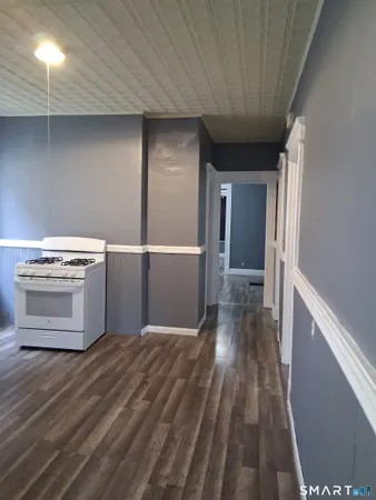 a view of a room with wooden floor and staircase