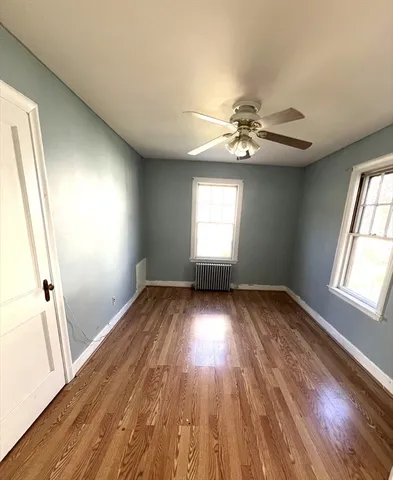 wooden floor in an empty room with a window