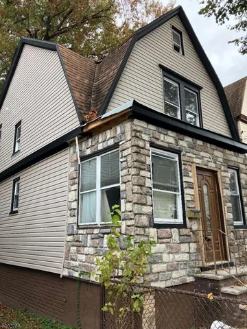 a front view of a house with large windows