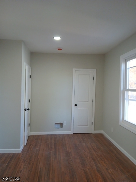 14 Ruth Street Irvington, NJ 07111 - Photo 11 of 15 an empty room with wooden floor and windows