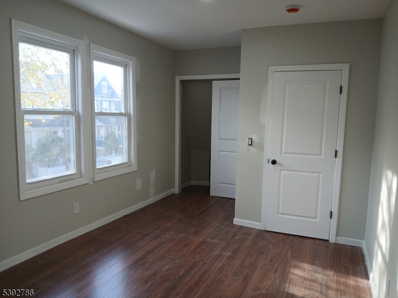 14 Ruth Street Irvington, NJ 07111 - Photo 14 of 15 a view of an empty room with wooden floor and a window