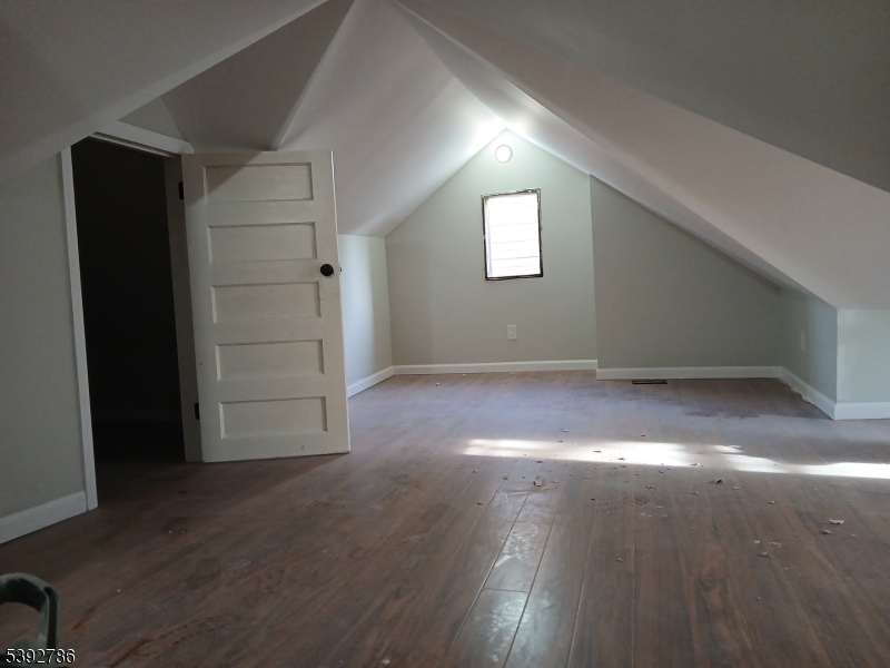 14 Ruth Street Irvington, NJ 07111 - Photo 15 of 15 an empty room with wooden floor and windows