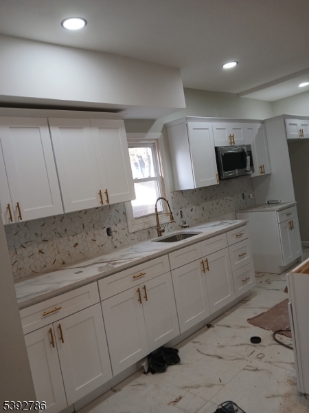 14 Ruth Street Irvington, NJ 07111 - Photo 4 of 15 a bathroom with a double vanity sink and mirror