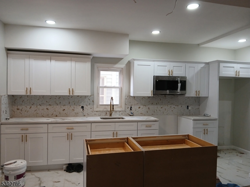 14 Ruth Street Irvington, NJ 07111 - Photo 5 of 15 a kitchen that has a sink and a stove in it