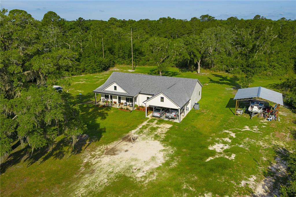 5149 Southwest 119th Road Lake Butler, FL 32054 - Photo 8 of 40 an aerial view of a house with swimming pool and garden view