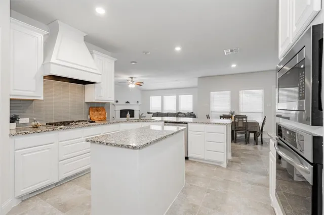 a kitchen with appliances a sink and cabinets