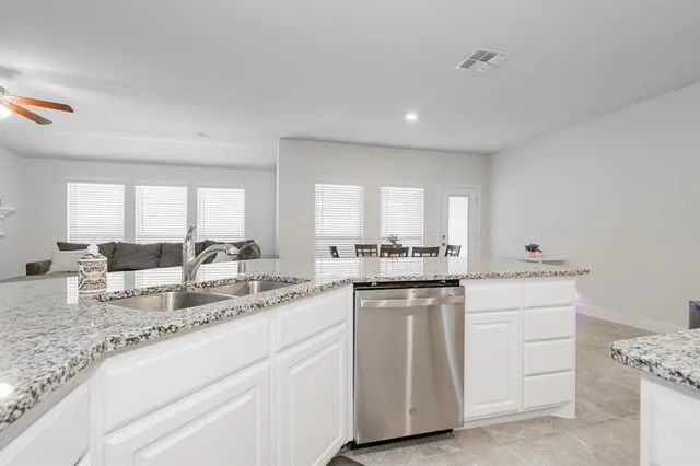 a front view of a house with a garden and yard