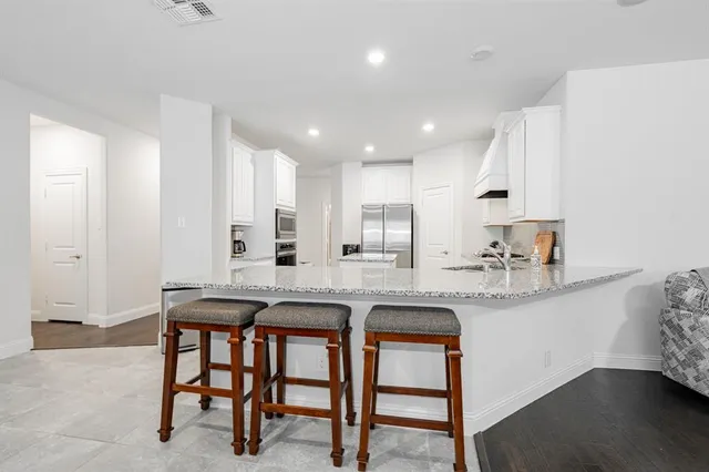 a view of kitchen with dining table and chairs