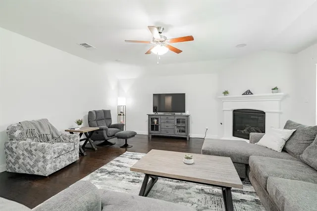 a kitchen with stainless steel appliances granite countertop a sink a stove a dining table and chairs