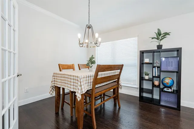 a view of a dining room with furniture wooden floor and chandelier