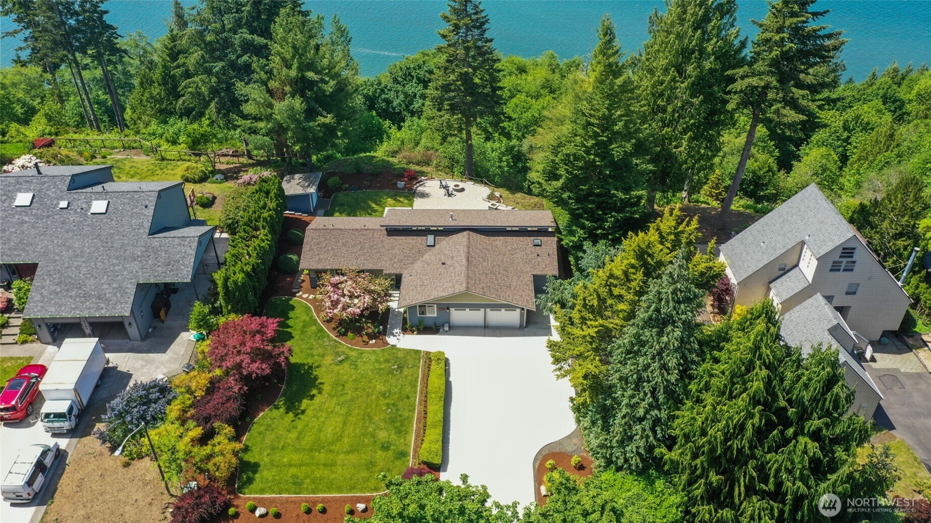 7713 78th Loop Northwest Olympia, WA 98502 - Photo 2 of 40 an aerial view of a house with a garden and trees