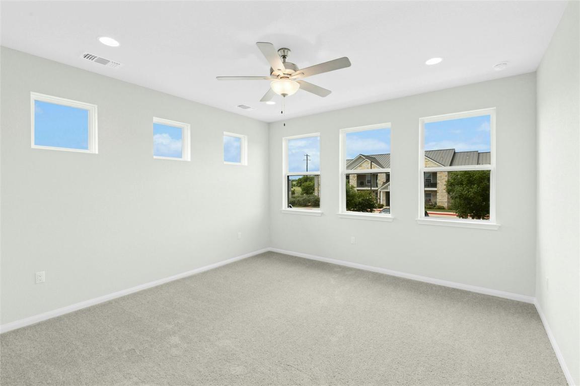 320 Creek Road, Unit 302 Dripping Springs, TX 78620 - Photo 6 of 21 Unfurnished room featuring carpet flooring, a ceiling fan, and recessed lighting