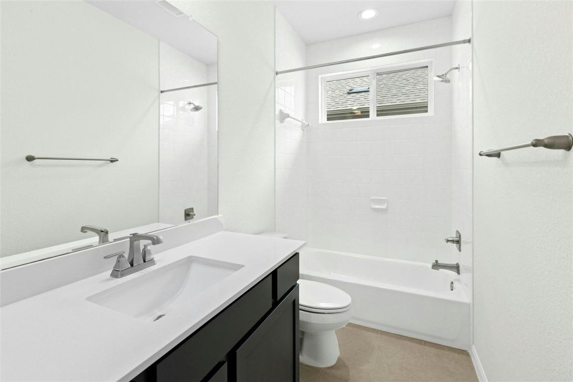 320 Creek Road, Unit 302 Dripping Springs, TX 78620 - Photo 9 of 21 Bathroom with shower / bath combination, vanity, and light tile patterned flooring