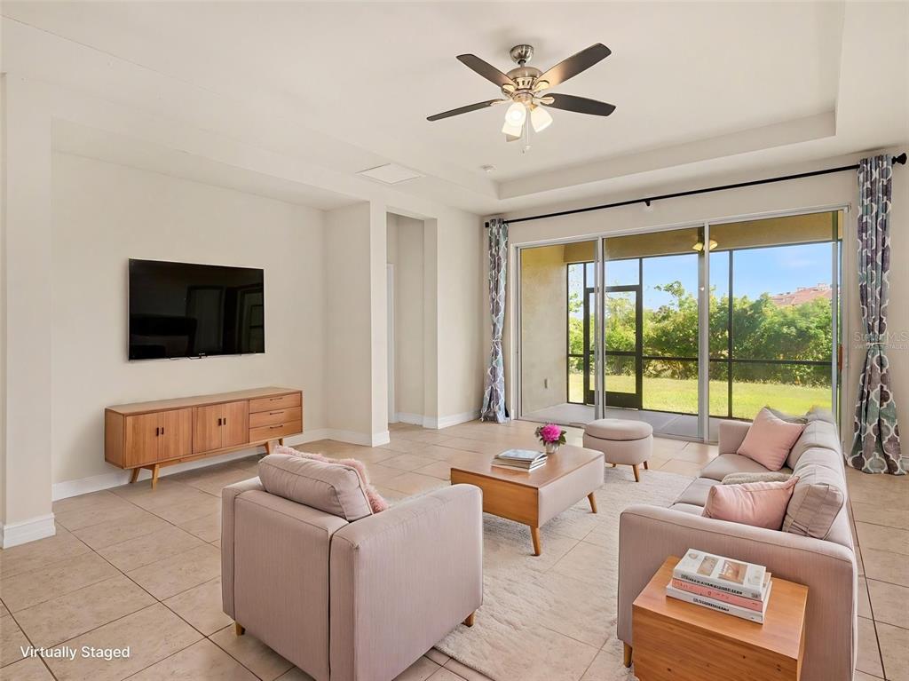 4429 Conchfish Lane Osprey, FL 34229 - Photo 6 of 20 a living room with furniture and a flat screen tv