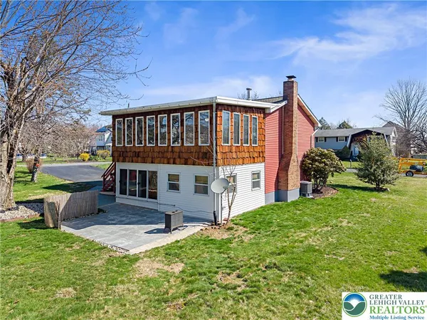 a view of a house with backyard porch and sitting area