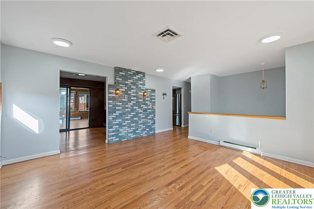 3945 Hemlock Place Bethlehem, PA 18017 - Photo 18 of 46 a view of an empty room with wooden floor and a window