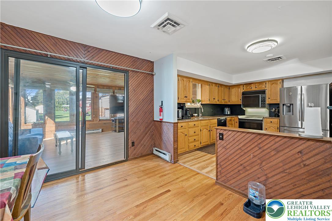 3945 Hemlock Place Bethlehem, PA 18017 - Photo 22 of 46 a large living room with stainless steel appliances granite countertop a stove and a view of kitchen