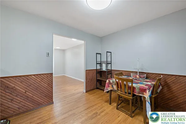 a view of a room with wooden floor furniture and windows