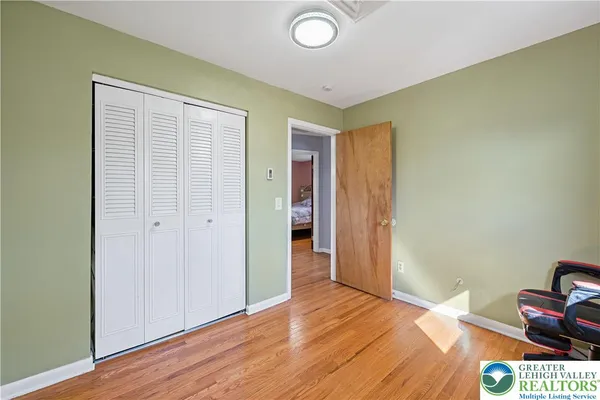 a view of room with wooden floor and closet