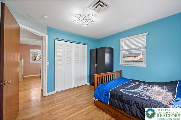 a bedroom with bed and a window