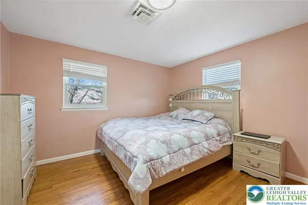 a bedroom with a bed and painting on the wall