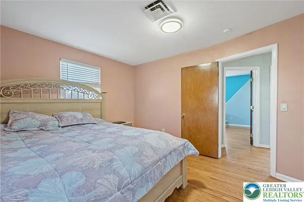 a bedroom with a bed and a dresser