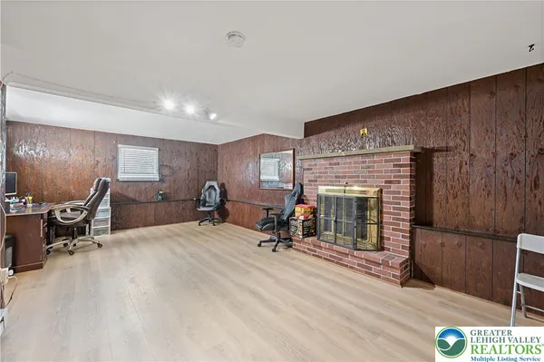 a view of a livingroom with workspace and a couch