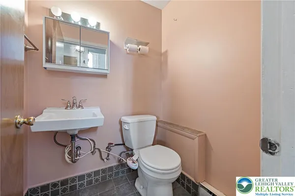 a bathroom with a toilet and a sink