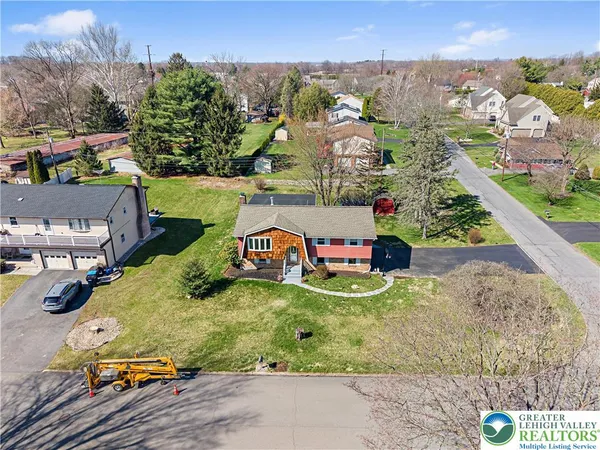 an aerial view of a house with a yard