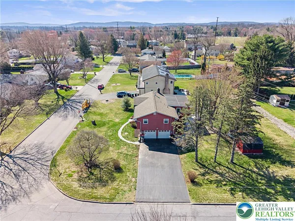 an aerial view of a house with a swimming pool yard and mountain view
