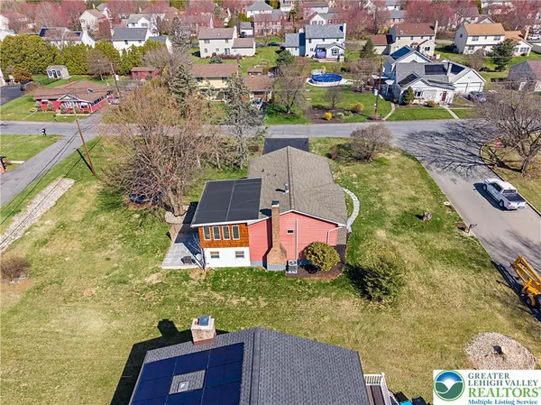 an aerial view of residential house with outdoor space and swimming pool