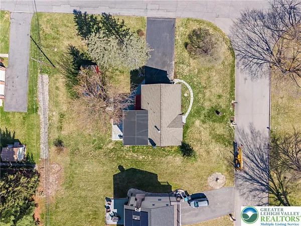 an aerial view of a house with yard swimming pool and outdoor seating