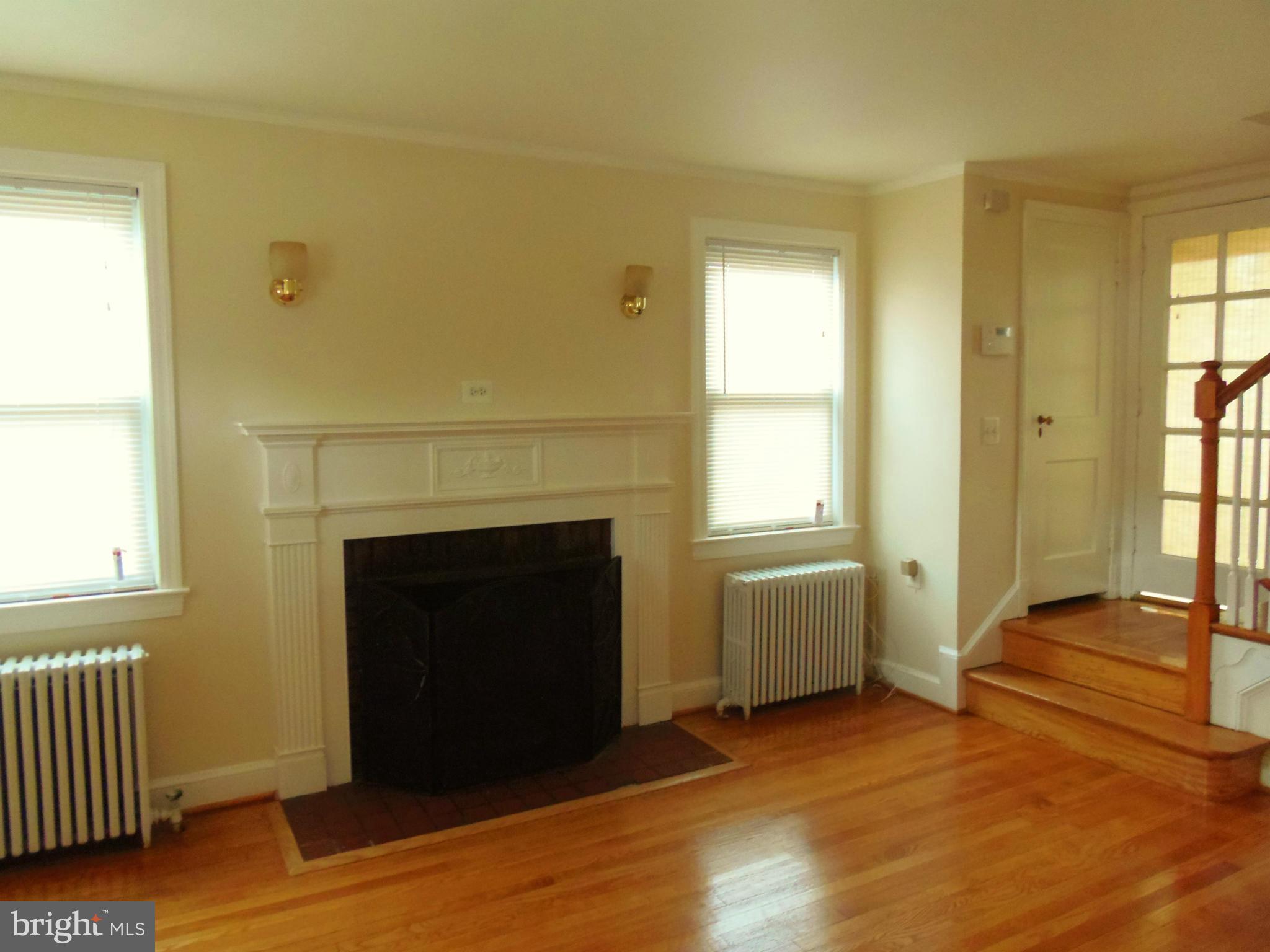2105 Brighton Road Hyattsville, MD 20782 - Photo 2 of 25 a view of an empty room with wooden floor and a window