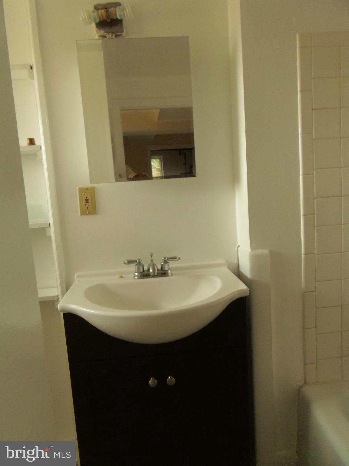 2105 Brighton Road Hyattsville, MD 20782 - Photo 19 of 25 a bathroom with a sink and a mirror