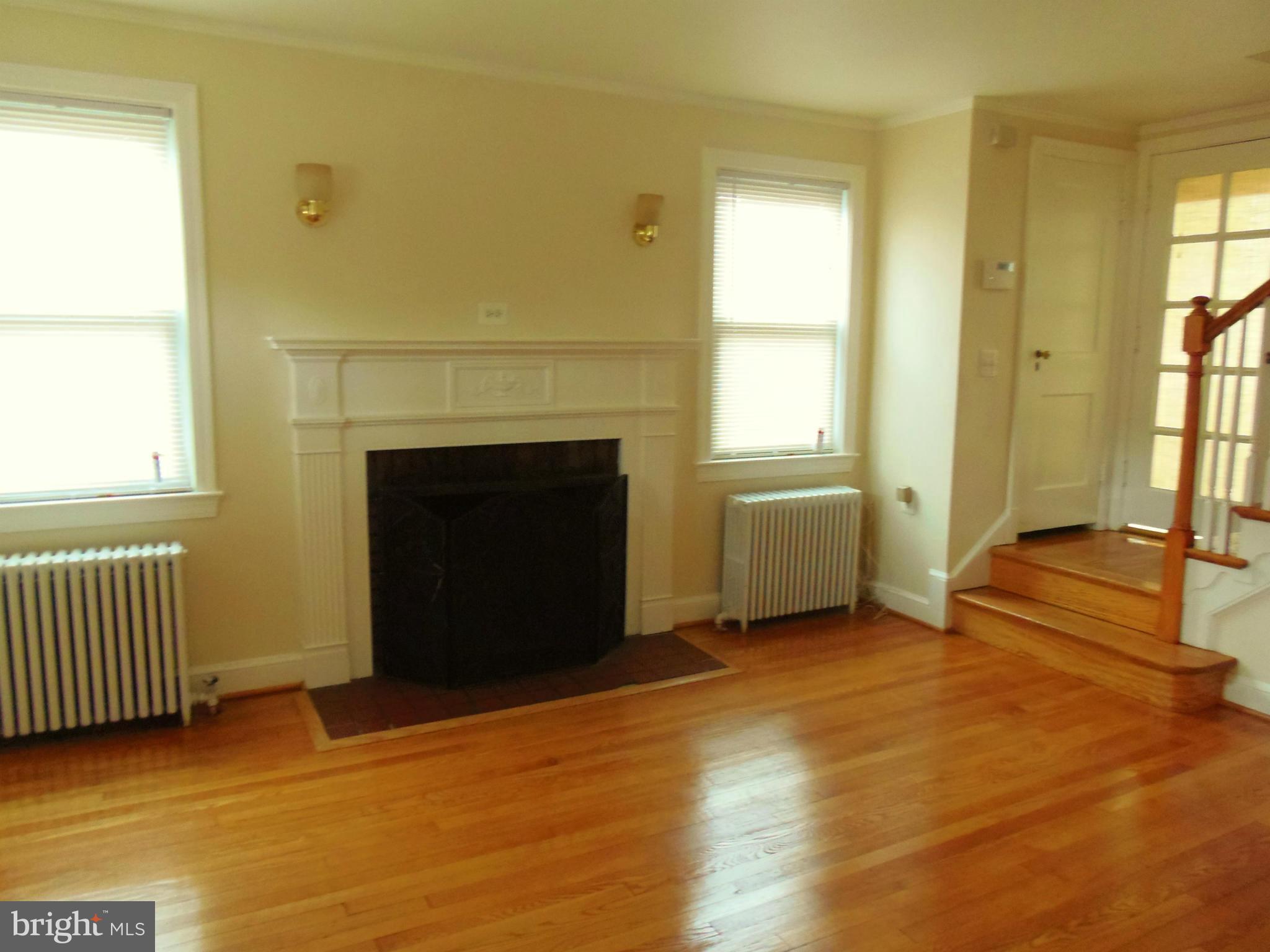 2105 Brighton Road Hyattsville, MD 20782 - Photo 4 of 25 a view of an empty room with a fireplace and a window