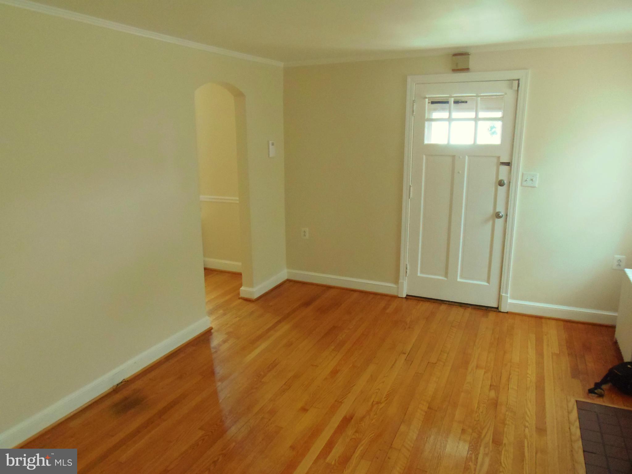 2105 Brighton Road Hyattsville, MD 20782 - Photo 6 of 25 an empty room with wooden floor and windows