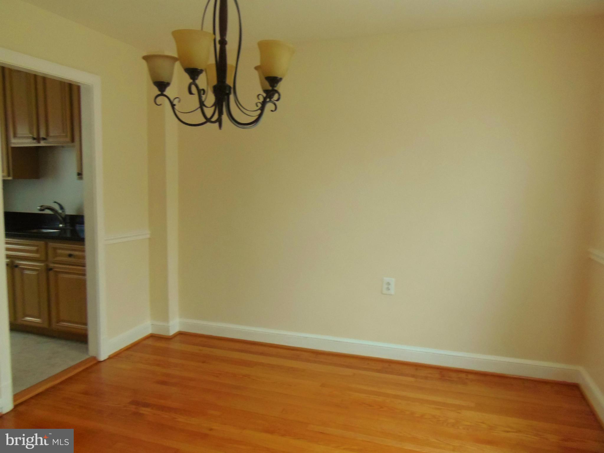 2105 Brighton Road Hyattsville, MD 20782 - Photo 7 of 25 a view of a room with wooden floor and white walls