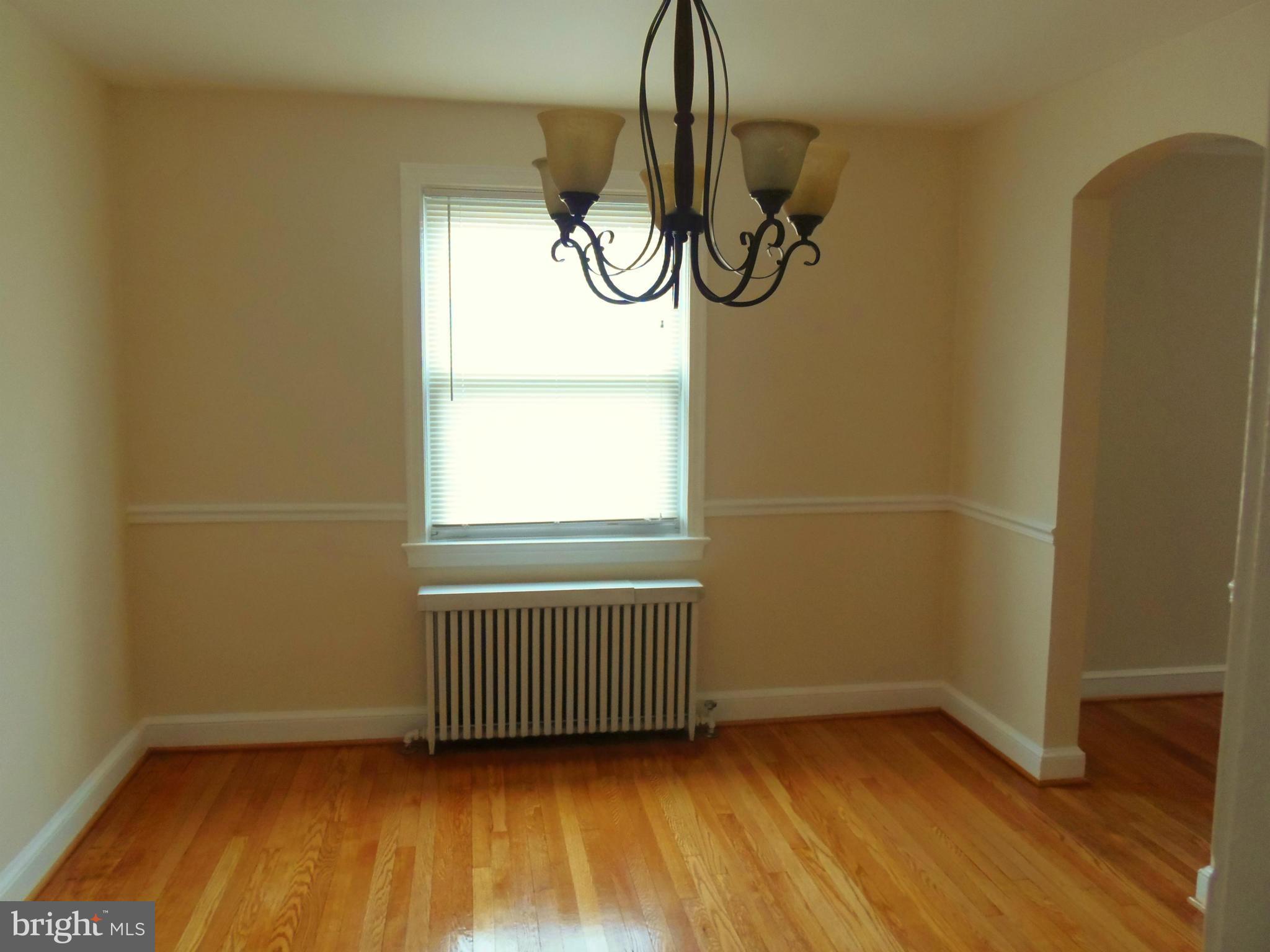 2105 Brighton Road Hyattsville, MD 20782 - Photo 8 of 25 a view of an empty room with wooden floor and window
