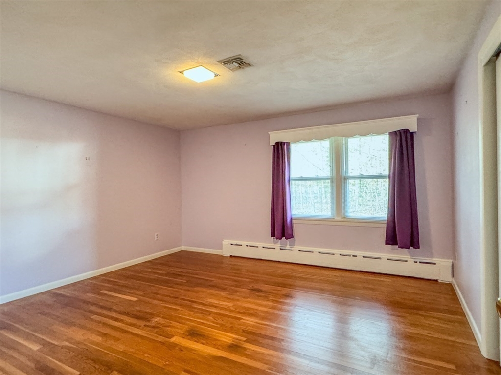 74 Petty Plain Road Greenfield, MA 01301 - Photo 12 of 42 a view of an empty room with wooden floor and a window
