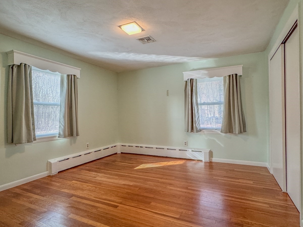 74 Petty Plain Road Greenfield, MA 01301 - Photo 14 of 42 wooden floor in an empty room with a window