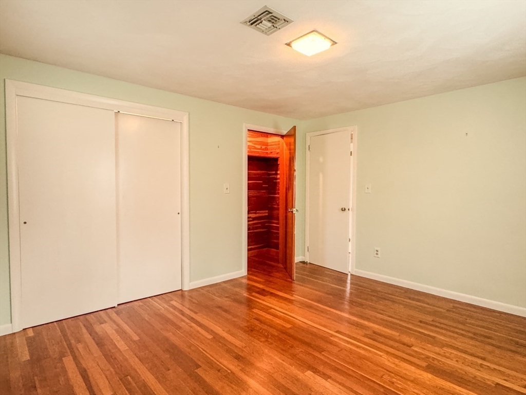 74 Petty Plain Road Greenfield, MA 01301 - Photo 15 of 42 an empty room with wooden floor and closet