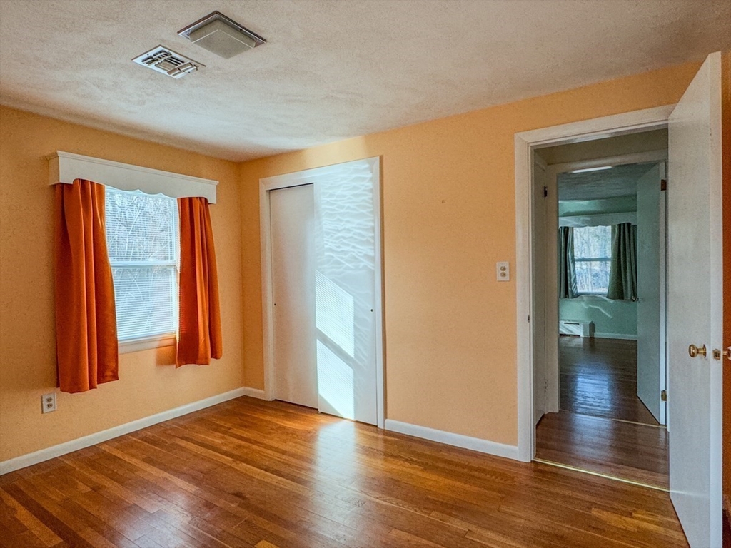 74 Petty Plain Road Greenfield, MA 01301 - Photo 19 of 42 wooden floor in an empty room with a window