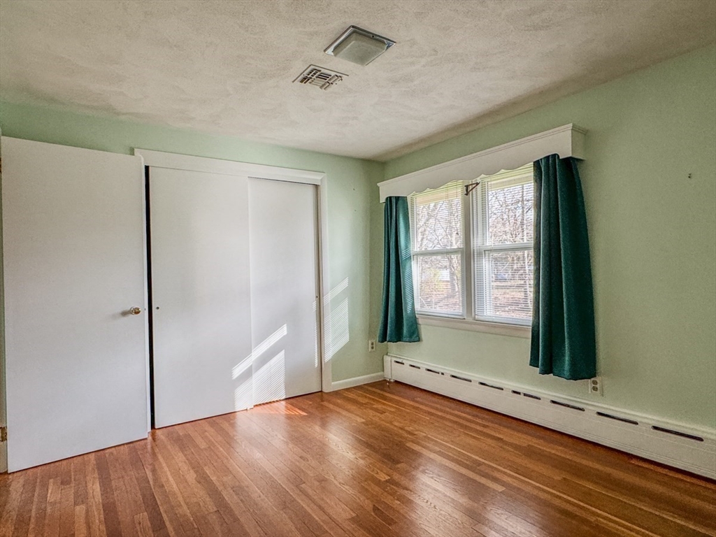 74 Petty Plain Road Greenfield, MA 01301 - Photo 20 of 42 a view of an empty room with a window and wooden floor