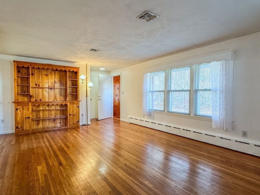 74 Petty Plain Road Greenfield, MA 01301 - Photo 3 of 42 an empty room with wooden floor and windows