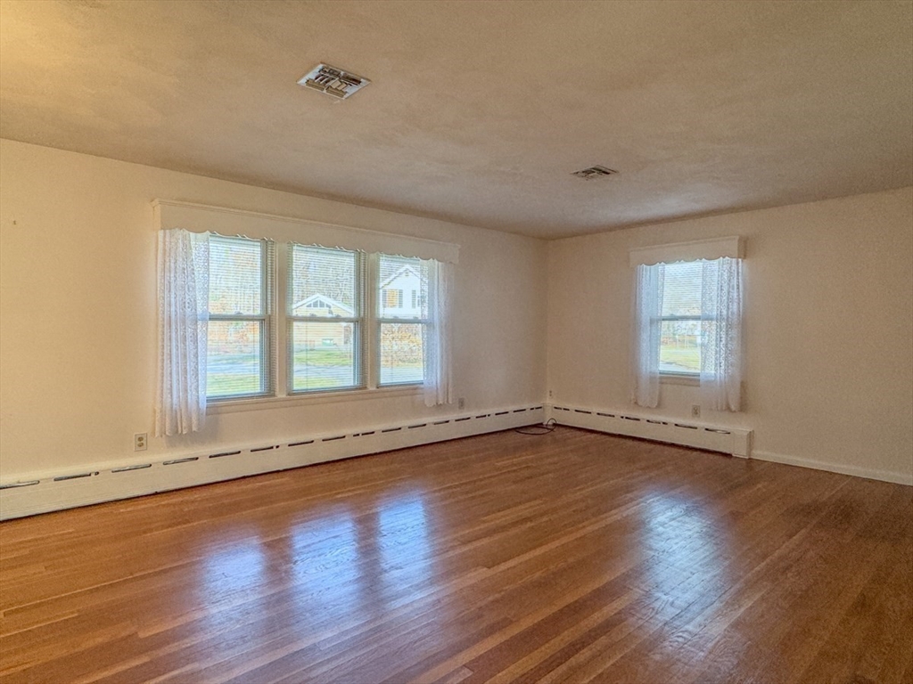 74 Petty Plain Road Greenfield, MA 01301 - Photo 4 of 42 an empty room with wooden floor and windows