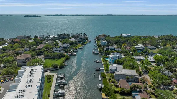 an aerial view of a city with lots of residential buildings ocean and mountain view