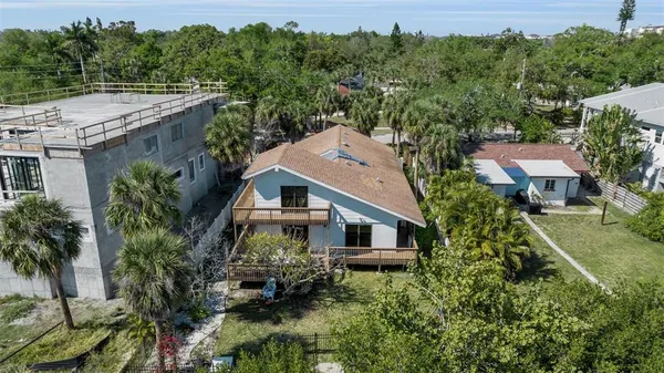 an aerial view of a house with a yard