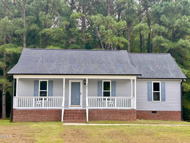a house that has a big tree in front of it