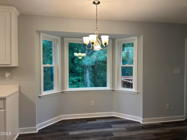 a kitchen with cabinets appliances a sink and a counter top space